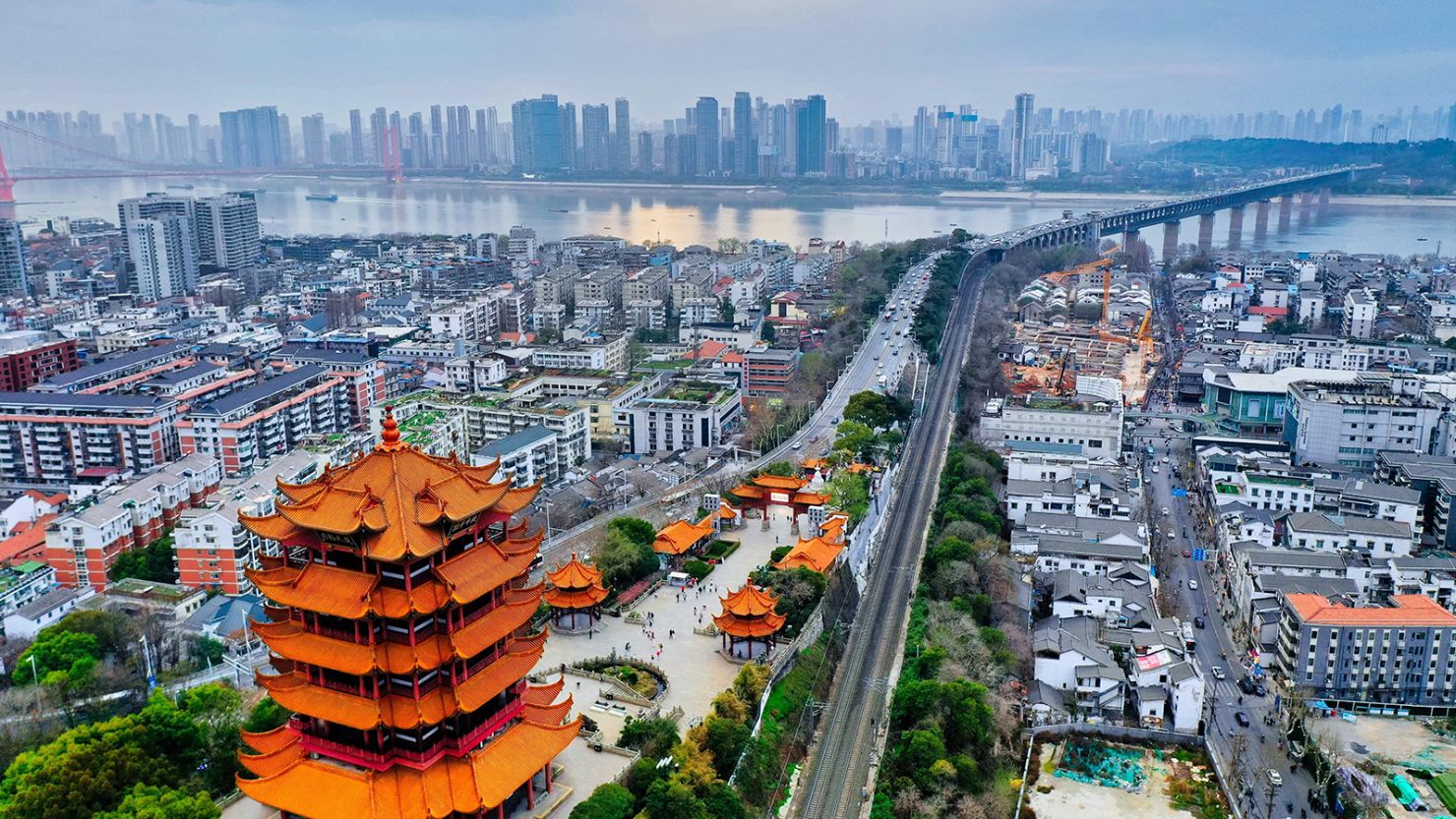 Breathtaking view of the Great Wall of China winding through mountains with traditional Chinese architecture in the background